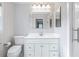 Bright bathroom with a white vanity, updated fixtures and a glass shower at 345 W Spalding Dr, Sandy Springs, GA 30328