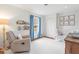 Bright Bedroom with blue curtains, a comfortable chair, a crib, and framed pictures on the wall at 345 W Spalding Dr, Sandy Springs, GA 30328