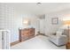 Bedroom features blue buffalo check wallpaper and light wood floors and furniture at 345 W Spalding Dr, Sandy Springs, GA 30328