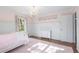 Bedroom with hardwood floors, a light pink color scheme, and recessed paneling and trim at 345 W Spalding Dr, Sandy Springs, GA 30328