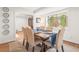 Cozy dining room boasts a rustic table setting and a window with garden views at 345 W Spalding Dr, Sandy Springs, GA 30328