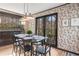 Charming dining room with floral wallpaper, black trim, and a black dining set at 345 W Spalding Dr, Sandy Springs, GA 30328