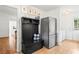 Entryway with coat rack and storage bench, stainless steel refrigerator and tile flooring at 345 W Spalding Dr, Sandy Springs, GA 30328
