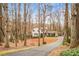 Charming two-story home with neutral siding, brick accents, dark shutters, long drive and a well-maintained front yard at 345 W Spalding Dr, Sandy Springs, GA 30328
