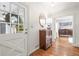Inviting foyer with hardwood floors, white trim, decorative mirror, and a view into the adjacent living spaces at 345 W Spalding Dr, Sandy Springs, GA 30328