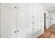 Hallway with large, white storage cabinets and wood floor at 345 W Spalding Dr, Atlanta, GA 30328