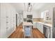 Bright kitchen with white cabinetry, updated appliances, and stylish wood floors at 345 W Spalding Dr, Sandy Springs, GA 30328