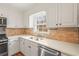 Bright kitchen with white cabinets, stainless steel appliances, and stone backsplash at 345 W Spalding Dr, Sandy Springs, GA 30328