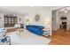 Bright living room with a stylish blue sofa, hardwood floors, and decorative accents at 345 W Spalding Dr, Sandy Springs, GA 30328