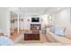 Inviting living room featuring a cozy seating area with a couch, patterned chair, and TV for entertainment at 345 W Spalding Dr, Sandy Springs, GA 30328