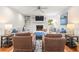 Cozy living room with fireplace, hardwood floors, and comfortable seating arrangements at 345 W Spalding Dr, Sandy Springs, GA 30328