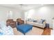 Bright living room with hardwood floors, comfy seating, and a blue ottoman at 345 W Spalding Dr, Sandy Springs, GA 30328