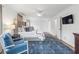 Well-lit main bedroom with a decorative rug, a cozy chair, and access to closet spaces at 345 W Spalding Dr, Sandy Springs, GA 30328