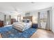 Spacious main bedroom with a plush bed, accent rug, and ample natural light from large windows at 345 W Spalding Dr, Sandy Springs, GA 30328