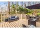 Relaxing outdoor patio space with lounge seating, table, chairs and shade umbrella at 345 W Spalding Dr, Sandy Springs, GA 30328