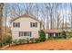 Classic two-story home featuring blue shutters, neutral siding, and a well-kept front yard at 345 W Spalding Dr, Sandy Springs, GA 30328