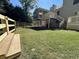 Green backyard with a raised wooden porch and fence with stairs at 3559 Sawmill Ter, Marietta, GA 30062