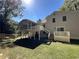 Spacious backyard with white house, large elevated screened porch and grassy area at 3559 Sawmill Ter, Marietta, GA 30062