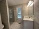 Remodeled bathroom with new marble tiling, glass shower door, new vanity, and modern fixtures at 3559 Sawmill Ter, Marietta, GA 30062