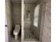Bright bathroom featuring marble tile, modern fixtures, and a sleek glass enclosed shower at 3559 Sawmill Ter, Marietta, GA 30062