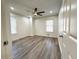 Bright bedroom featuring luxury vinyl flooring, a ceiling fan, and natural light from two windows at 3559 Sawmill Ter, Marietta, GA 30062