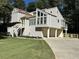 Exterior view of a light-colored home with multiple windows and a well-maintained lawn at 3559 Sawmill Ter, Marietta, GA 30062