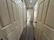 Hallway with a bathroom view, showcasing multiple closets with paneled doors at 3559 Sawmill Ter, Marietta, GA 30062