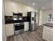 Bright kitchen with stainless steel appliances, granite countertops, and mosaic tile backsplash at 3559 Sawmill Ter, Marietta, GA 30062