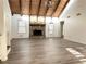 Spacious living room featuring exposed beams, vaulted ceilings, and a stone fireplace at 3559 Sawmill Ter, Marietta, GA 30062