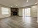 Spacious living room with luxury vinyl flooring, a stone fireplace, and a sliding glass door at 3559 Sawmill Ter, Marietta, GA 30062