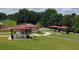 A community park showcases picnic tables under red roofed shelters amidst green lawns, a relaxing place for all at 3559 Sawmill Ter, Marietta, GA 30062