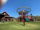 Outdoor playground featuring a merry-go-round and a colorful play structure with slides for Gathering fun and activity at 3559 Sawmill Ter, Marietta, GA 30062