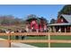 Exterior playground view, featuring a red and green barn themed play structure that adds joy to Gathering time at 3559 Sawmill Ter, Marietta, GA 30062