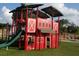 View of the Mabry Park playground area with a bright and colorful barn themed jungle gym and slide at 3559 Sawmill Ter, Marietta, GA 30062
