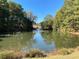 Scenic view of a pond with a fountain, surrounded by lush greenery, creating a peaceful retreat at 3559 Sawmill Ter, Marietta, GA 30062