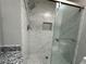 Close-up of the elegant walk-in shower with marble-look tiling, glass doors, and modern fixtures at 3559 Sawmill Ter, Marietta, GA 30062