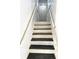 Clean, bright stairway featuring white railings and two-toned steps for easy access between floors at 3559 Sawmill Ter, Marietta, GA 30062