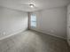 Bedroom featuring neutral walls, carpet, and window overlooking backyard at 4963 Arbor View Nw Pkwy, Acworth, GA 30101