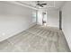 A spacious carpeted bedroom featuring neutral walls, a ceiling fan, and access to an ensuite at 4963 Arbor View Nw Pkwy, Acworth, GA 30101