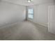 Bedroom with light gray paint, carpet, a double hung window and white door at 4963 Arbor View Nw Pkwy, Acworth, GA 30101