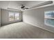 Spacious carpeted bedroom boasts tray ceilings and a ceiling fan at 4963 Arbor View Nw Pkwy, Acworth, GA 30101