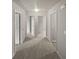 Upstairs hallway featuring neutral carpet and white doors that lead to bedrooms or other rooms at 4963 Arbor View Nw Pkwy, Acworth, GA 30101