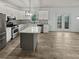 Open kitchen featuring white cabinets, stainless steel appliances, an island with granite countertops, and access to outdoor deck at 4963 Arbor View Nw Pkwy, Acworth, GA 30101