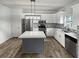 Modern kitchen featuring an island, stainless steel appliances, white cabinets and granite countertops at 4963 Arbor View Nw Pkwy, Acworth, GA 30101