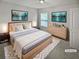 A staged main bedroom with light walls, carpet, artwork, and a ceiling fan at 4963 Arbor View Nw Pkwy, Acworth, GA 30101