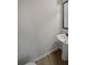 Small powder room featuring a pedestal sink and wood-look flooring; convenient for guests at 4963 Arbor View Nw Pkwy, Acworth, GA 30101