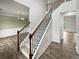 Grand two-story foyer showcasing a staircase with wooden handrail and iron spindles, complemented by wood-look flooring at 4963 Arbor View Nw Pkwy, Acworth, GA 30101