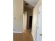 Hallway with laminate flooring leading to additional rooms and an open floor plan at 740 Kibbe Cir, Lawrenceville, GA 30044