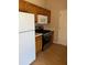 Kitchen featuring white appliances, wooden cabinets, gas range, and neutral colors at 740 Kibbe Cir, Lawrenceville, GA 30044