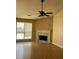 Spacious living room with hardwood floors, fireplace, ceiling fan, and natural light at 740 Kibbe Cir, Lawrenceville, GA 30044